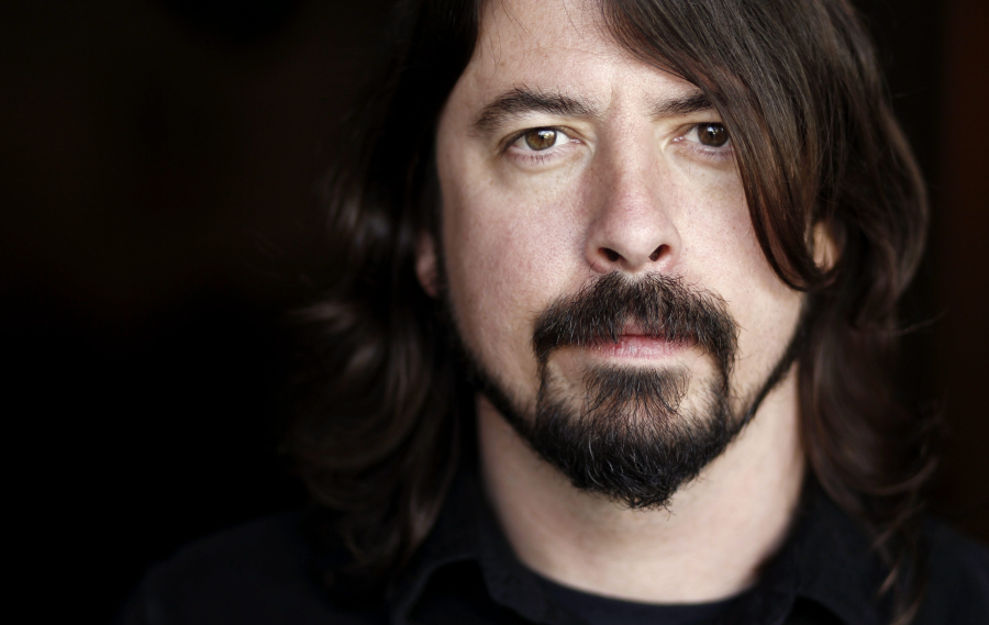 FILE - In this Jan. 31, 2012 file photo, musician Dave Grohl poses for a portrait in Los Angeles. The often eloquent Foo Fighters frontman has signed on to give the keynote speech at the 2013 South By Southwest Music Conference on March 14 in Austin, Texas. He's also working on his Sound City documentary and new Queens Of The Stone Age material with Josh Homme. Both are expected to be early released early next year. (AP Photo/Matt Sayles, file)
